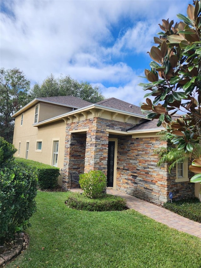 view of side of home featuring a lawn