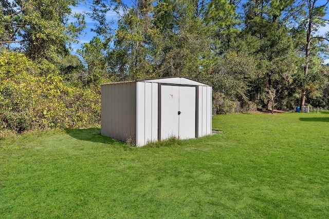 view of outbuilding featuring a lawn