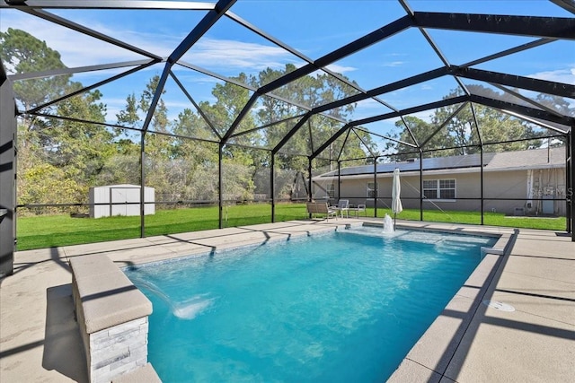 view of swimming pool featuring a patio, a storage shed, a lanai, pool water feature, and a yard