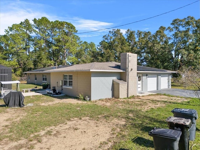 exterior space with a yard and a garage