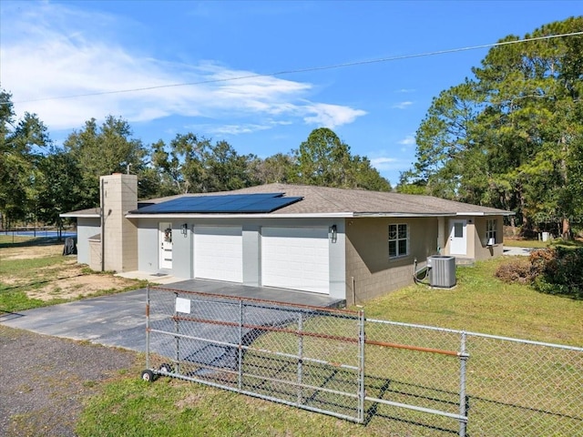 222 Rod Ln, Davenport, FL 33837 - view of home's exterior with an attached garage, driveway, concrete block siding, solar panels, and roof with shingles