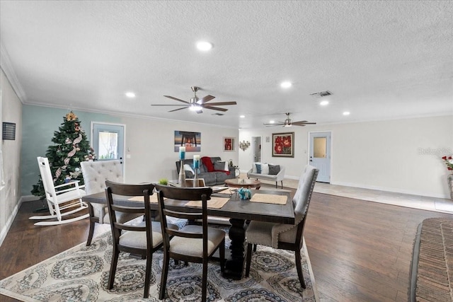 dining space featuring a textured ceiling, dark hardwood / wood-style flooring, ceiling fan, and ornamental molding