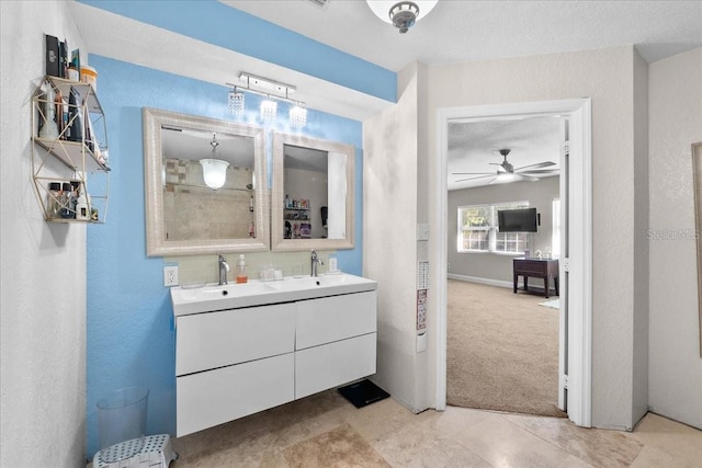 bathroom featuring a textured ceiling, vanity, and ceiling fan