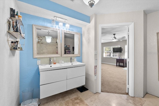 222 Rod Ln, Davenport, FL 33837 - bathroom featuring double vanity, a textured wall, a ceiling fan, and tile patterned floors
