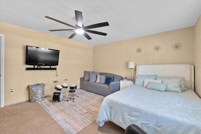 carpeted bedroom with ceiling fan and a textured ceiling