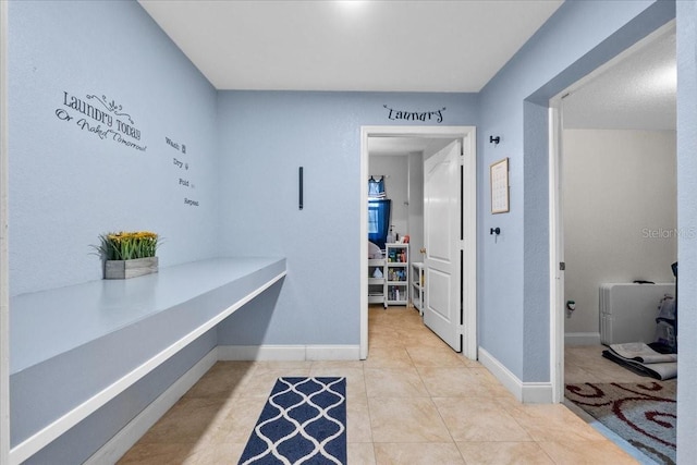 hall with light tile patterned floors