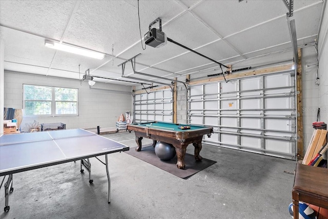 222 Rod Ln, Davenport, FL 33837 - rec room featuring concrete floors, a garage, pool table, and concrete block wall