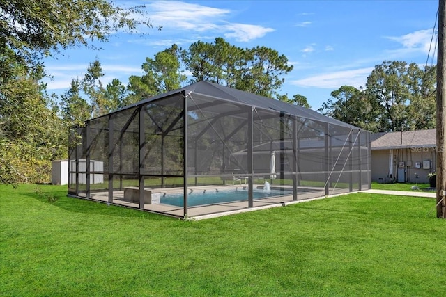 view of pool featuring glass enclosure, a yard, and a storage unit