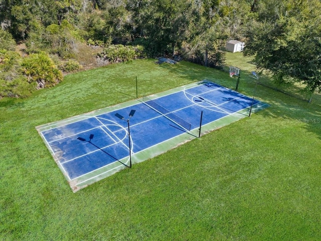 view of basketball court featuring a yard