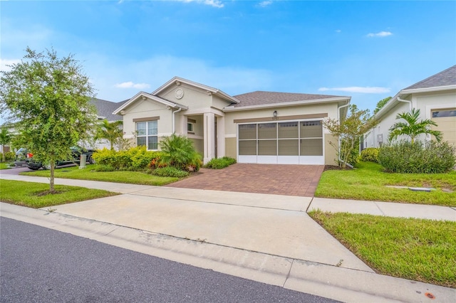 view of front of house with a front yard and a garage