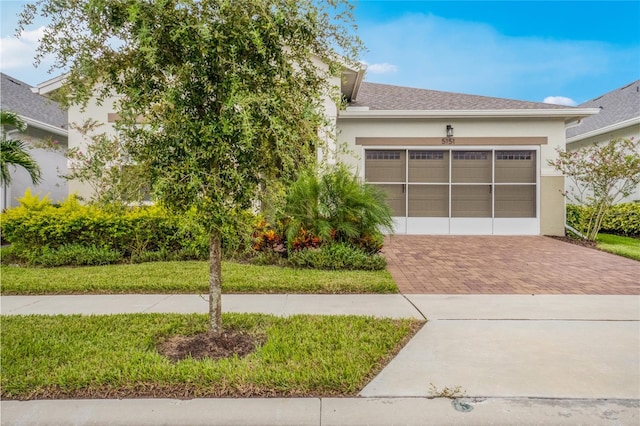 view of property hidden behind natural elements featuring a garage