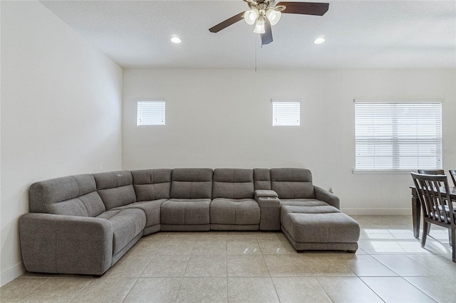 living room featuring ceiling fan and a wealth of natural light