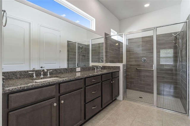 bathroom featuring vanity, tile patterned flooring, and walk in shower