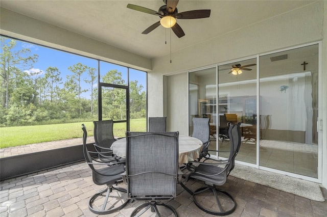 sunroom featuring ceiling fan