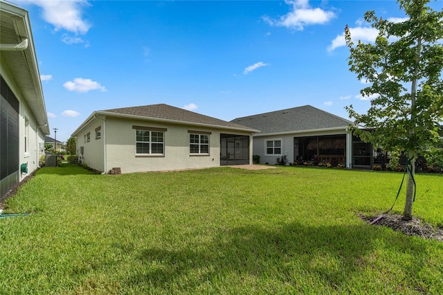 rear view of house with a yard, cooling unit, and a sunroom