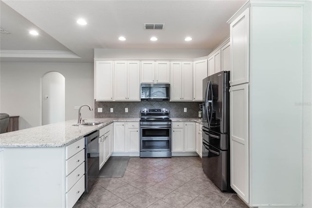 kitchen with white cabinetry, sink, light stone counters, kitchen peninsula, and black appliances