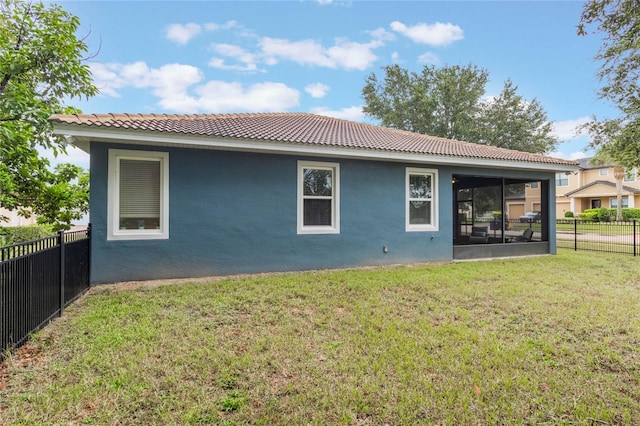 back of house featuring a sunroom and a yard