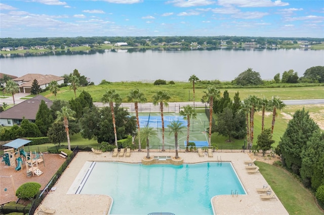 view of pool with a playground and a water view