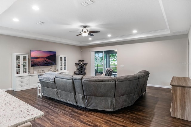 living room featuring ceiling fan, crown molding, and dark hardwood / wood-style floors