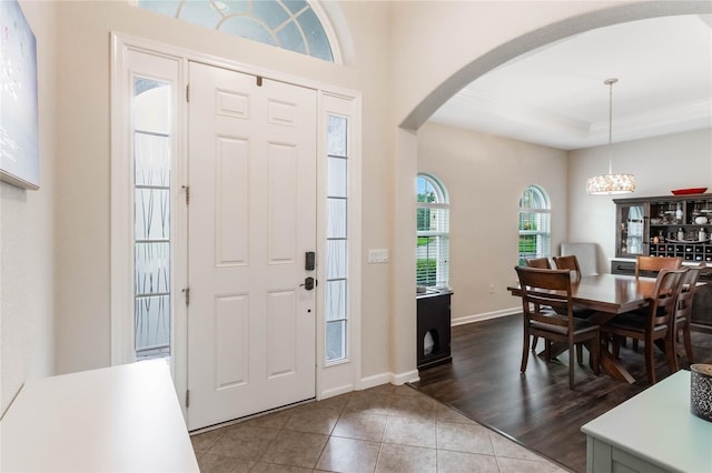 entryway featuring a chandelier and wood-type flooring