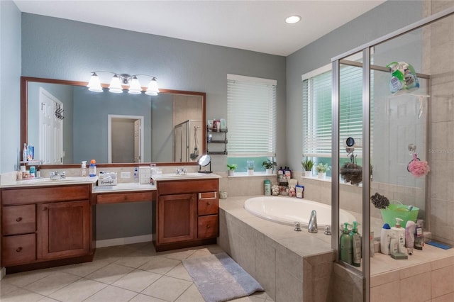 bathroom with tile patterned floors, vanity, and shower with separate bathtub