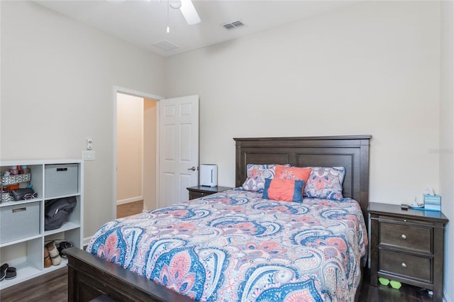 bedroom with dark hardwood / wood-style flooring and ceiling fan