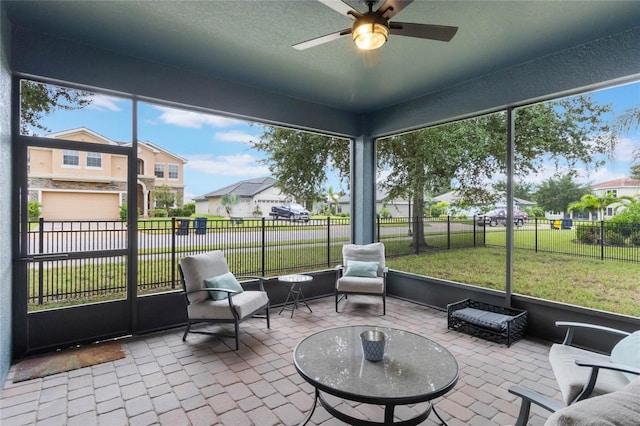 sunroom / solarium featuring ceiling fan