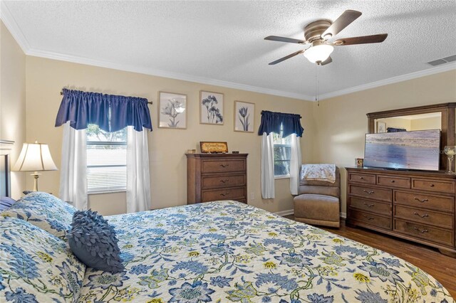 bedroom featuring a textured ceiling, ceiling fan, crown molding, and dark hardwood / wood-style floors