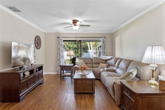 living room with a textured ceiling, dark wood-style flooring, visible vents, a ceiling fan, and crown molding