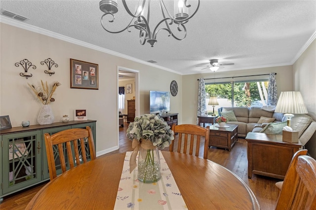 dining area with a textured ceiling and ornamental molding