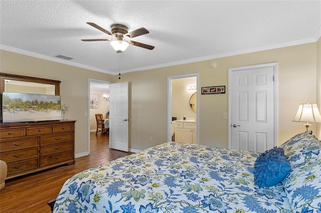 bedroom featuring connected bathroom, a textured ceiling, ceiling fan, and crown molding