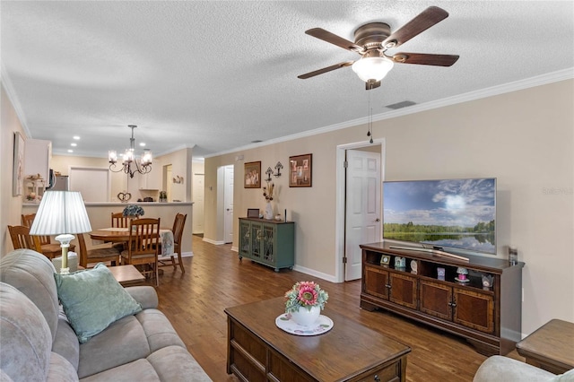 living room with ceiling fan with notable chandelier, a textured ceiling, crown molding, and dark hardwood / wood-style flooring