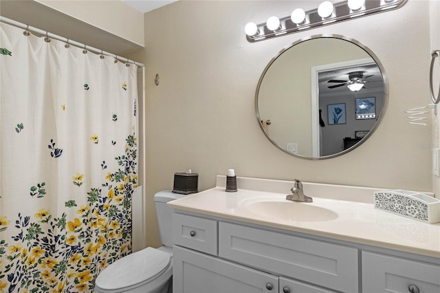 bathroom featuring ceiling fan, curtained shower, vanity, and toilet