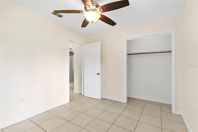 unfurnished bedroom featuring light tile patterned floors, a closet, visible vents, and baseboards