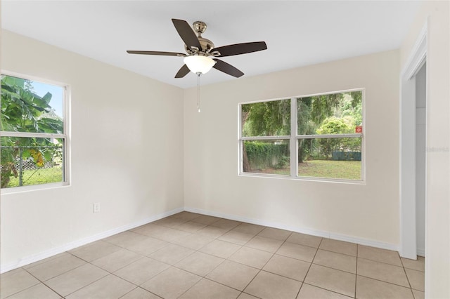 unfurnished room with a healthy amount of sunlight, baseboards, and light tile patterned floors