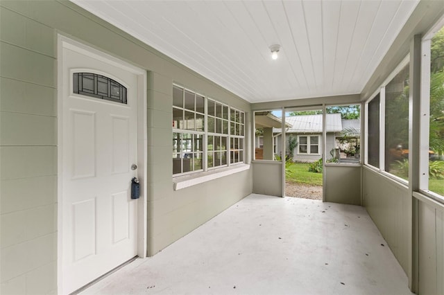 unfurnished sunroom with wooden ceiling