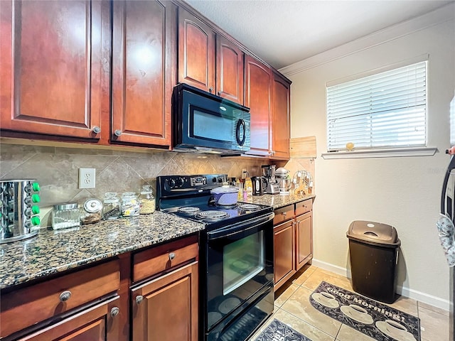 kitchen with dark stone counters, ornamental molding, decorative backsplash, light tile patterned floors, and black appliances