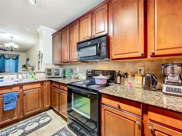 902 Charo Pkwy Unit 624, Davenport, FL 33897 - kitchen with black appliances, a sink, a chandelier, backsplash, and light stone countertops