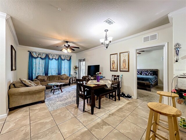 902 Charo Pkwy Unit 624, Davenport, FL 33897 - dining room featuring crown molding, light tile patterned floors, ceiling fan, a textured ceiling, and a chandelier