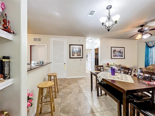 902 Charo Pkwy Unit 624, Davenport, FL 33897 - dining area featuring ornamental molding, ceiling fan, light tile patterned flooring, baseboards, and a chandelier