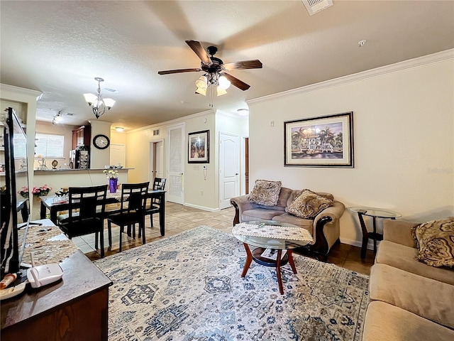 tiled living room featuring a textured ceiling, ceiling fan with notable chandelier, and ornamental molding