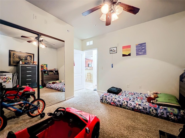 bedroom featuring carpet flooring, ceiling fan, and a closet