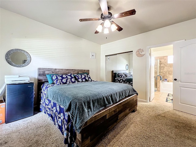 902 Charo Pkwy Unit 624, Davenport, FL 33897 - bedroom featuring light carpet, a closet, ceiling fan, ensuite bath, and light tile patterned floors