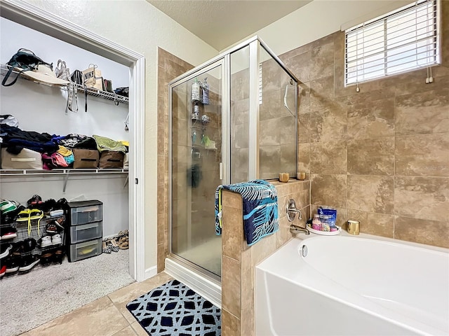 bathroom featuring plus walk in shower and tile patterned floors