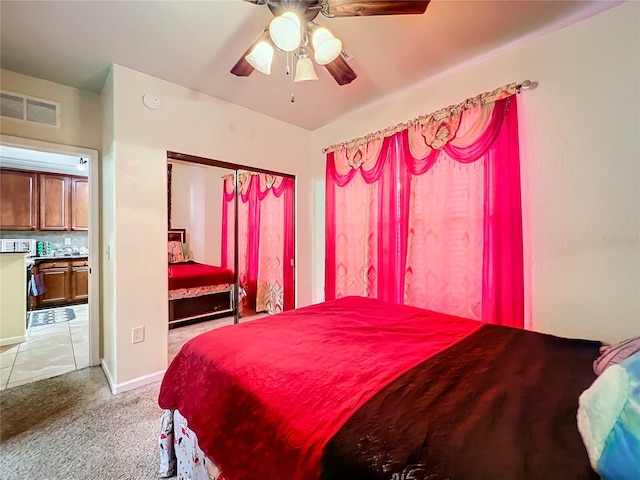 bedroom with light tile patterned flooring and ceiling fan