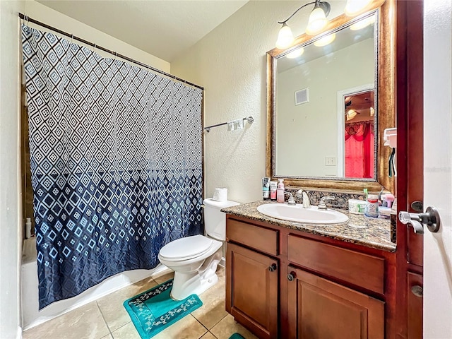 902 Charo Pkwy Unit 624, Davenport, FL 33897 - bathroom featuring a textured wall, vanity, tile patterned floors, toilet, and shower / tub combo