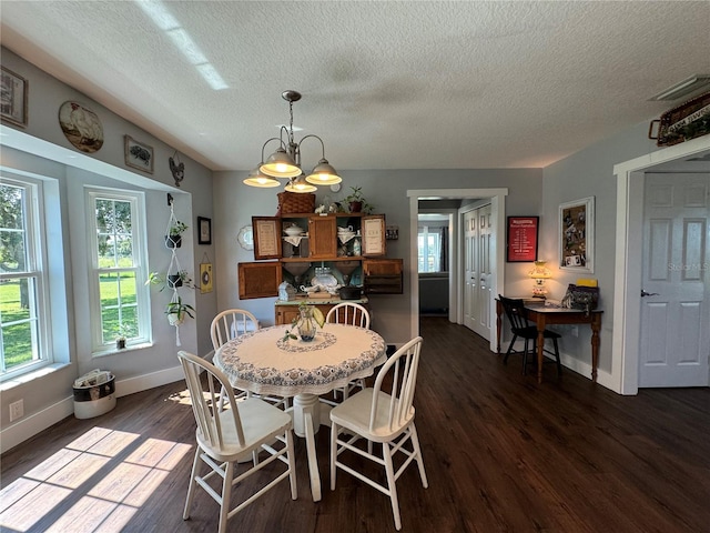 dining area featuring a healthy amount of sunlight, dark wood-type flooring, and a chandelier