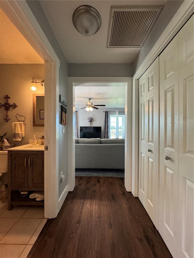 hall featuring dark hardwood / wood-style flooring and sink