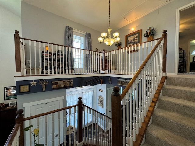 stairs with a notable chandelier