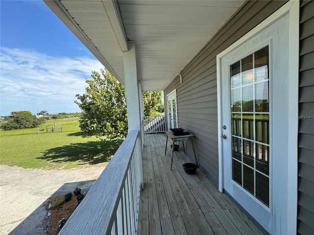 wooden deck featuring a lawn